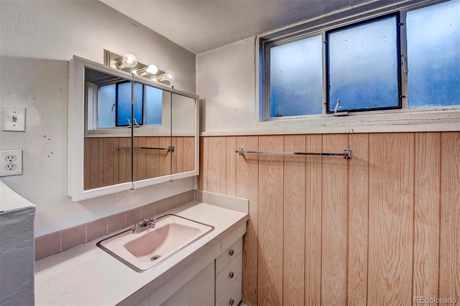 3880 Allison Street Wheat Ridge, CO 80033 - Photo 16 of 18 a bathroom with a sink and a mirror