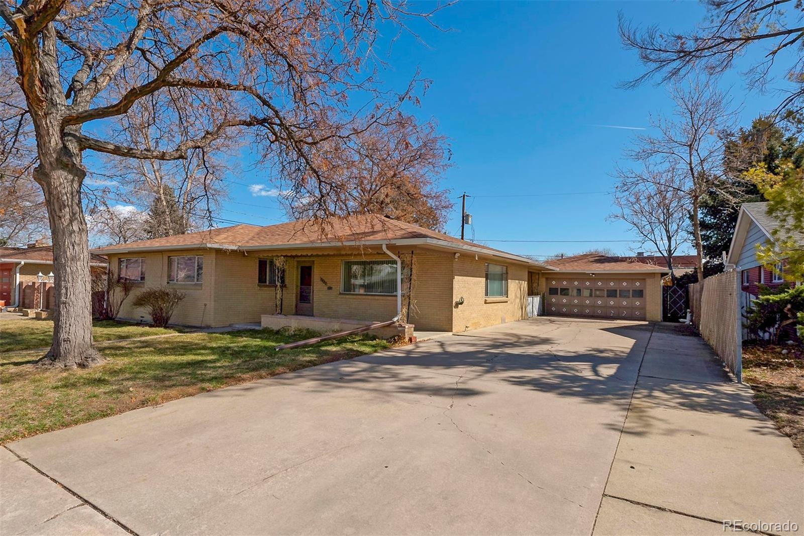 3880 Allison Street Wheat Ridge, CO 80033 - Photo 2 of 18 a view of a house with a yard covered in snow
