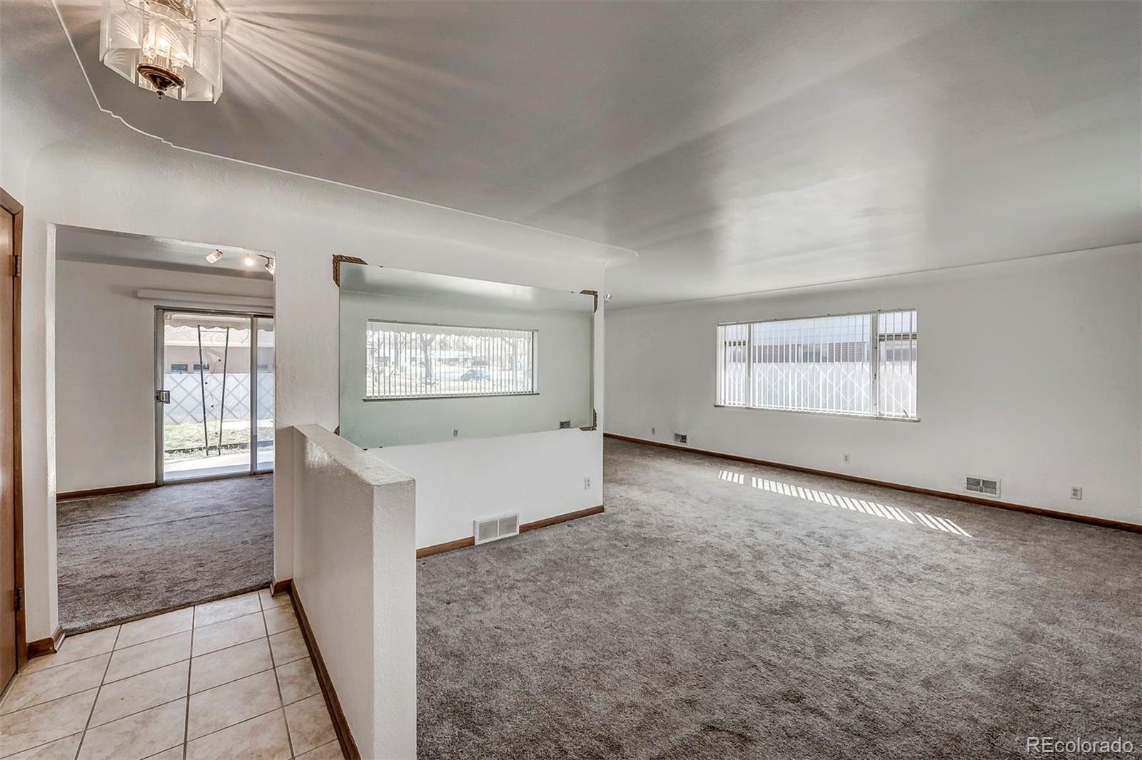 3880 Allison Street Wheat Ridge, CO 80033 - Photo 3 of 18 an empty room with windows and fireplace