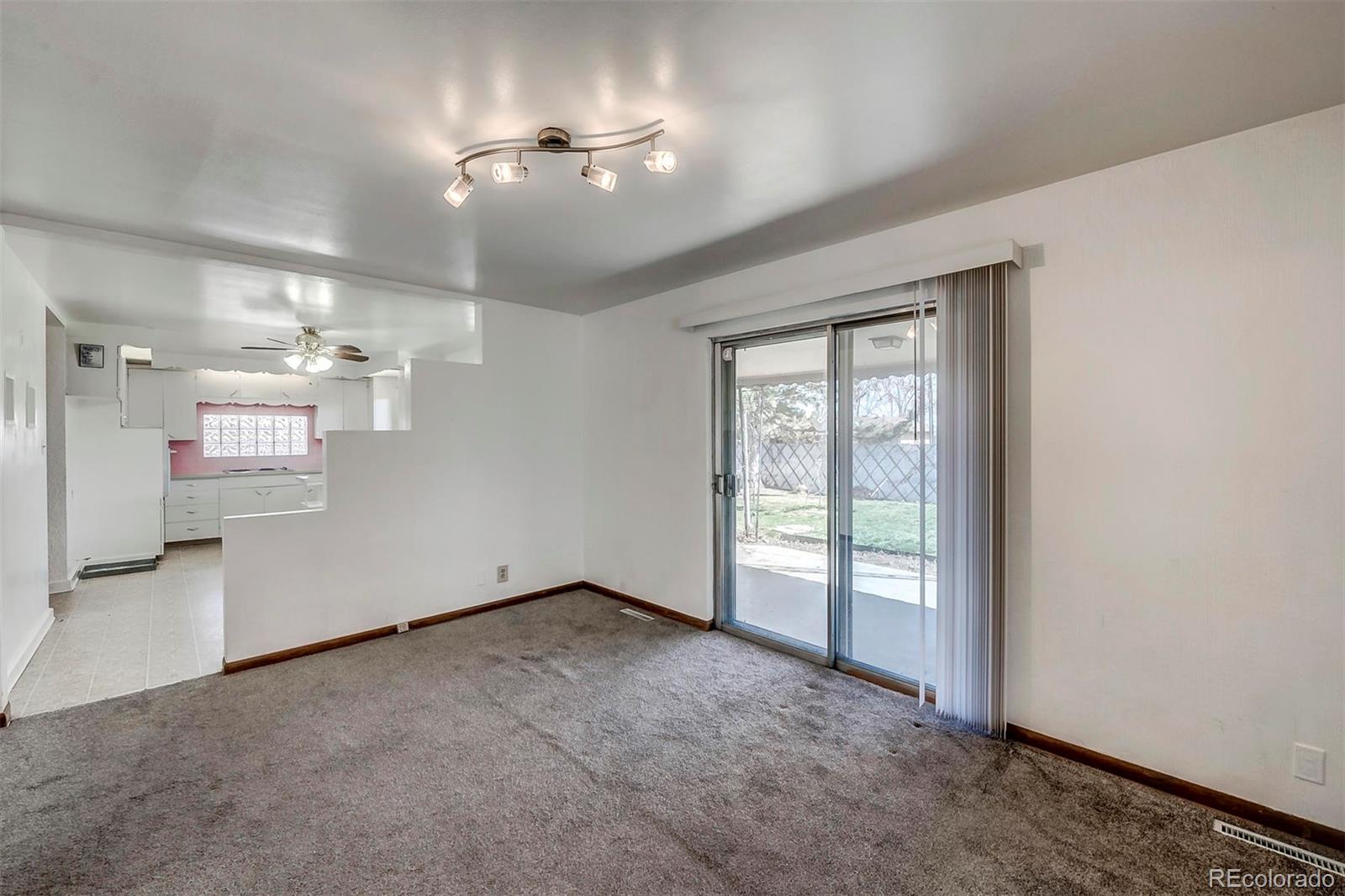 3880 Allison Street Wheat Ridge, CO 80033 - Photo 7 of 18 an empty room with windows and fan