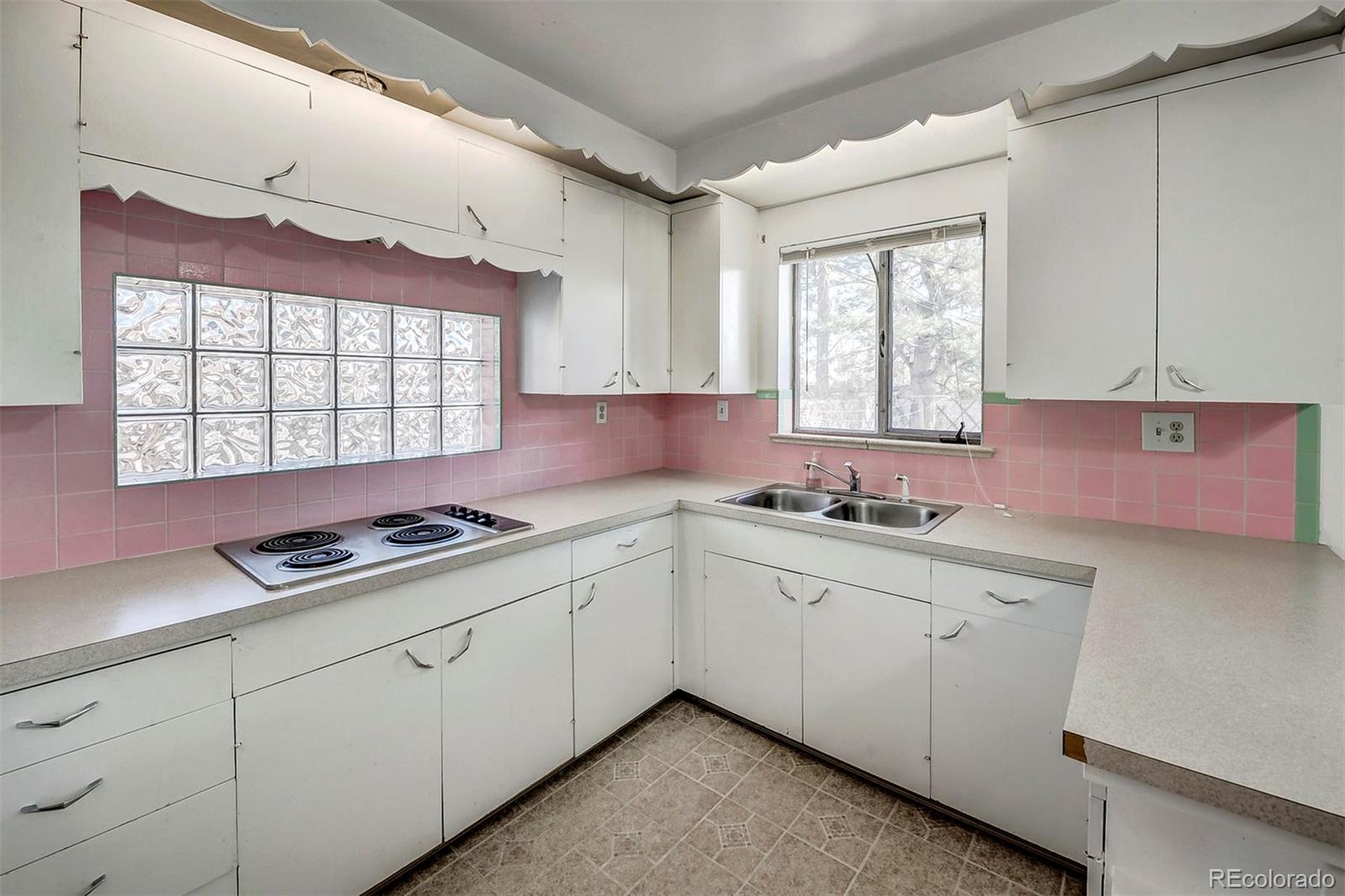 3880 Allison Street Wheat Ridge, CO 80033 - Photo 9 of 18 a kitchen that has a sink and a stove