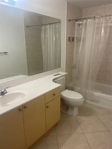 a bathroom with a toilet a sink a shower and a mirror