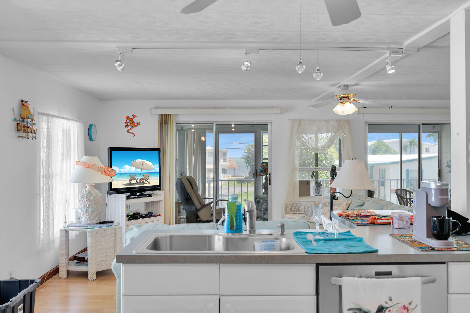 606 North Silver Circle Key Largo, FL 33037 - Photo 13 of 54 a kitchen with sink refrigerator and window