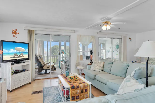 a room with furniture or chandelier and a large window