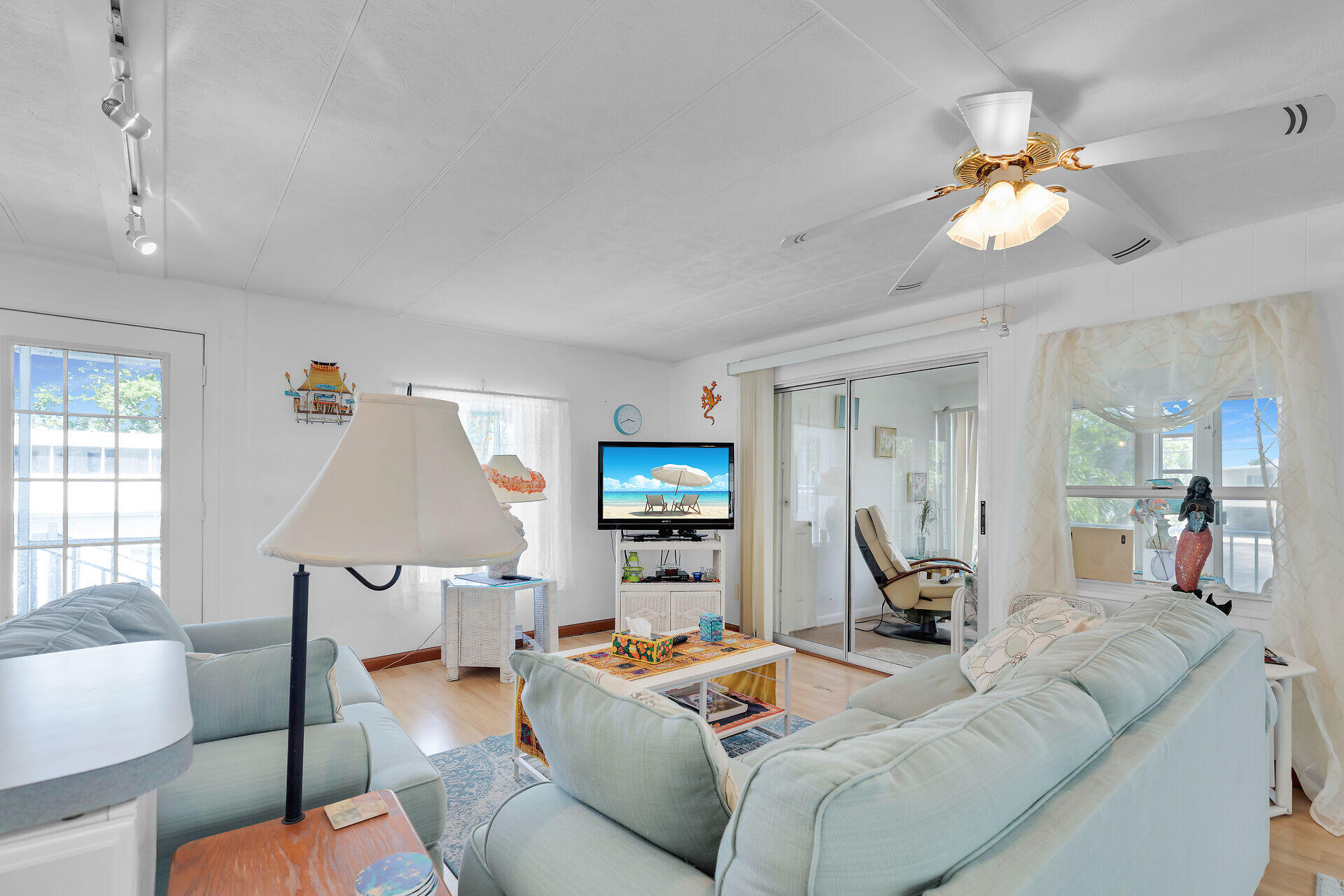 606 North Silver Circle Key Largo, FL 33037 - Photo 15 of 54 a living room with furniture a window and a flat screen tv