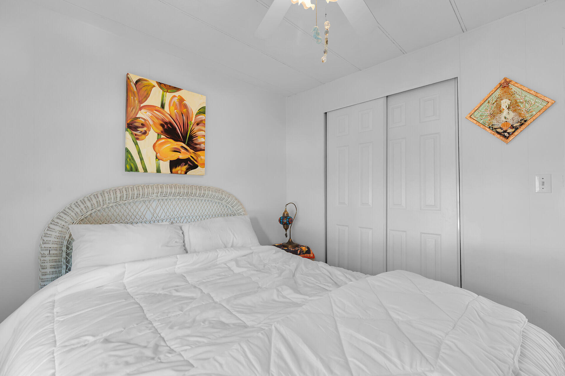 606 North Silver Circle Key Largo, FL 33037 - Photo 32 of 54 a bedroom with a bed and painting on the wall