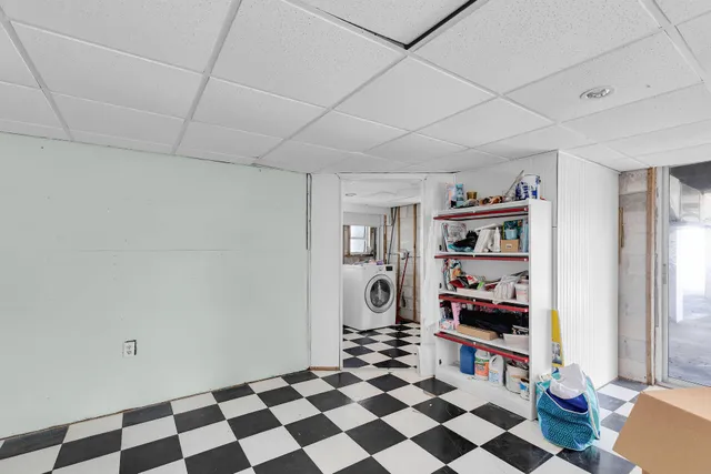 a view of garage with a car parked in it