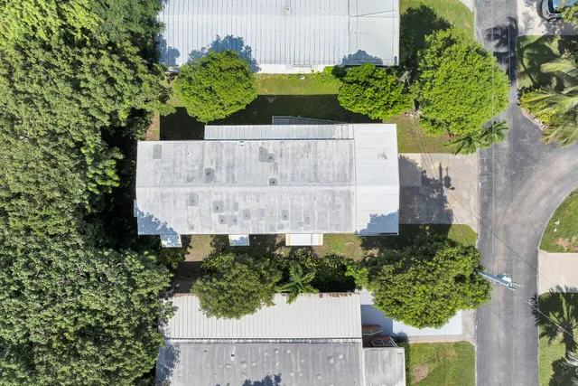 an aerial view of a house with a swimming pool an outdoor seating