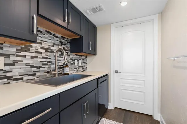 a en suite bathroom with a granite countertop sink and a mirror