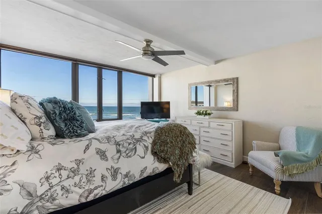 a view of a balcony with two chairs and a potted plant