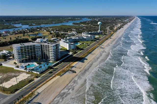 a living room with furniture kitchen view and a flat screen tv