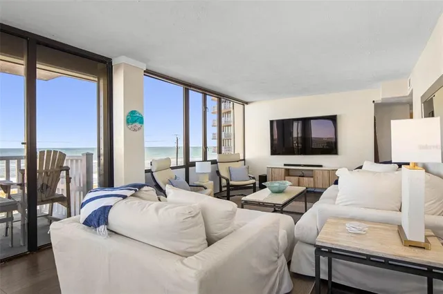 a dining room with furniture and a floor to ceiling window