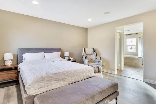 a bedroom with a bed and a view of living room