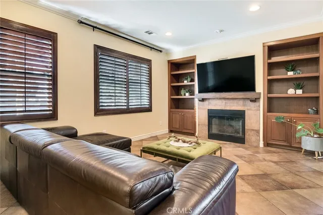 a living room with furniture fireplace and flat screen tv