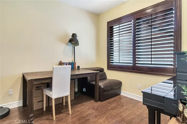a dining room with furniture and a window
