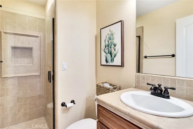 a bathroom with a sink toilet and mirror