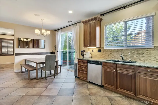 a open kitchen with granite countertop a sink and a stove top oven
