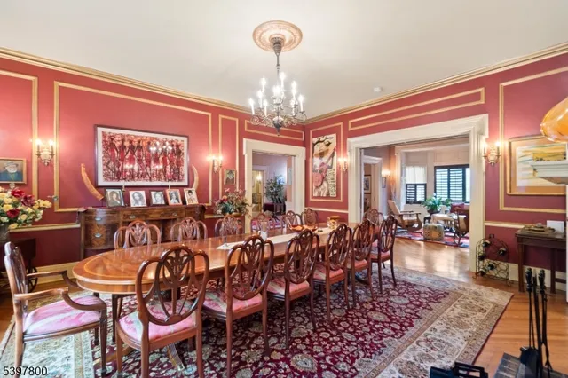 a view of a dining room with furniture a chandelier and wooden floor