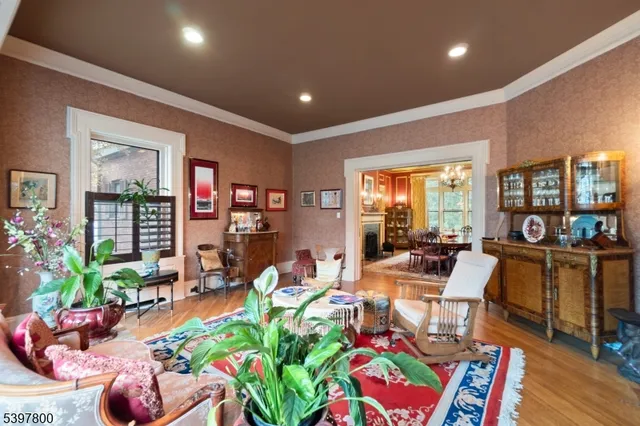 a living room filled with furniture and a potted plant