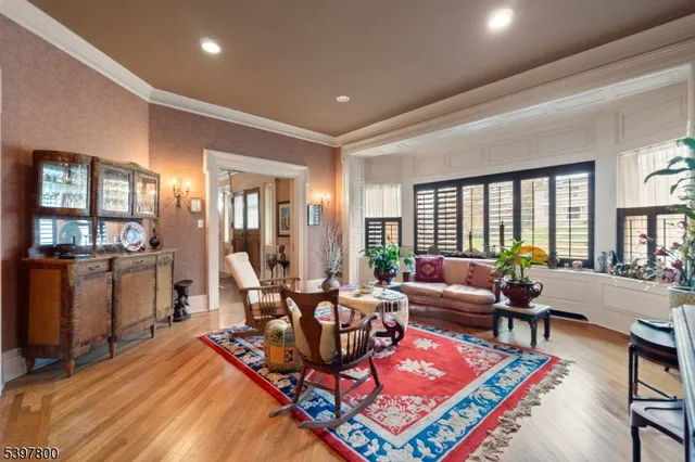 a living room with furniture a rug and a window
