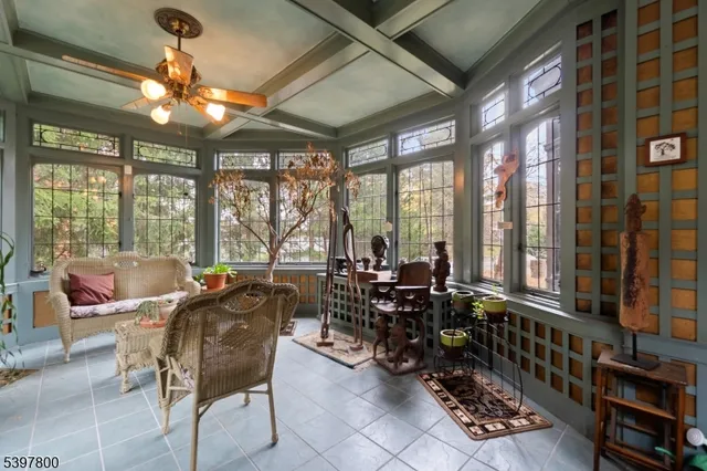 a room with lots of chairs and large windows