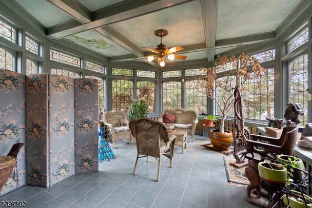 a living room with patio furniture and a large window