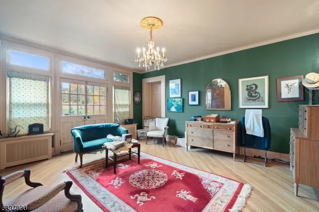a living room with furniture and a chandelier