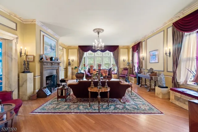 a living room with fireplace furniture and a chandelier