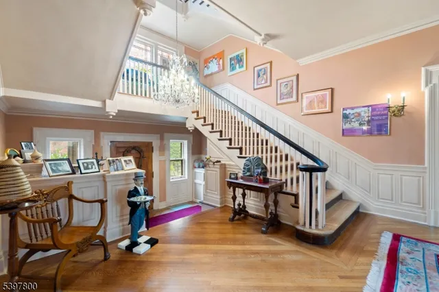 a view of entryway and hall with wooden floor