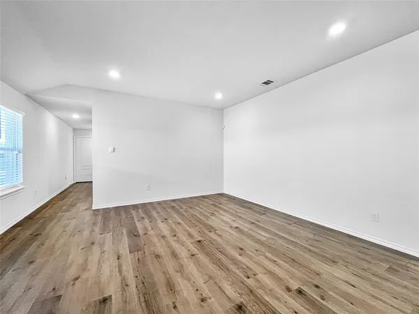 an empty room with wooden floor