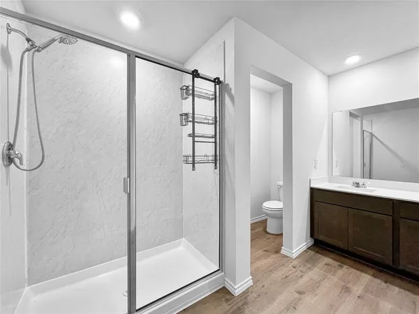 a bathroom with a shower and a glass door