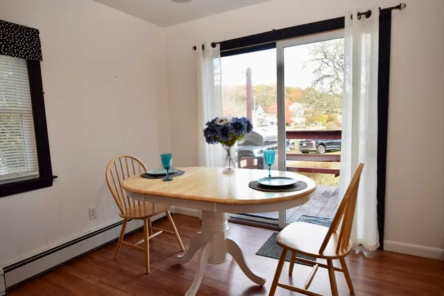 a dining room with furniture and wooden floor