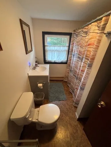 a bathroom with a toilet and a window