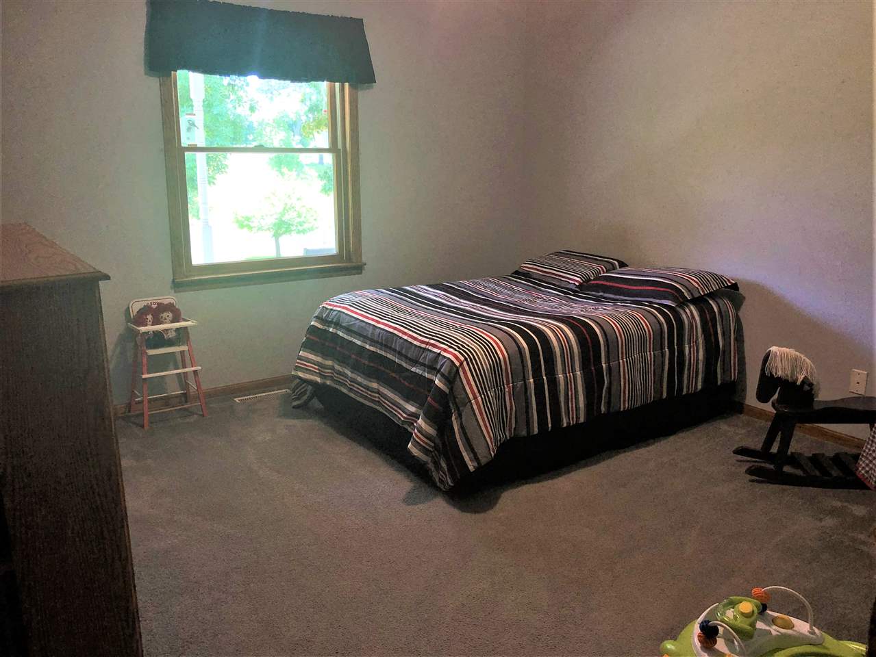 6652 North Cedar Road Forreston, IL 61030 - Photo 12 of 25 a bed sitting in a bedroom next to a window