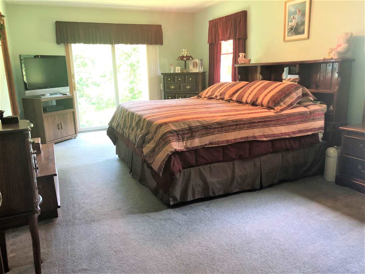 6652 North Cedar Road Forreston, IL 61030 - Photo 14 of 25 a bedroom with a bed and a flat screen tv