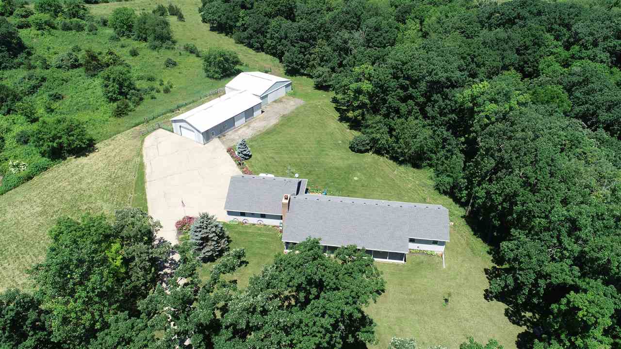 6652 North Cedar Road Forreston, IL 61030 - Photo 21 of 25 an aerial view of a house with a yard and trees all around