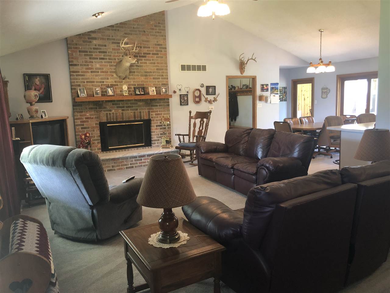6652 North Cedar Road Forreston, IL 61030 - Photo 3 of 25 a living room with furniture a fireplace a lamp and a large window