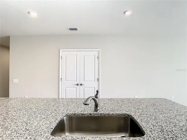 a bathroom with a sink and a granite counter tops