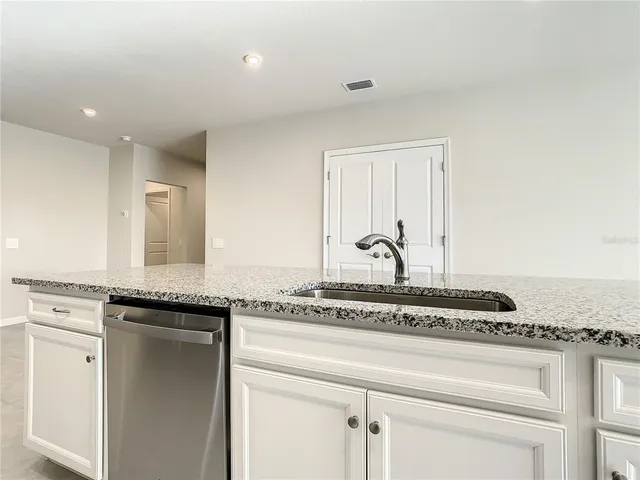 a view of a kitchen counter space and windows