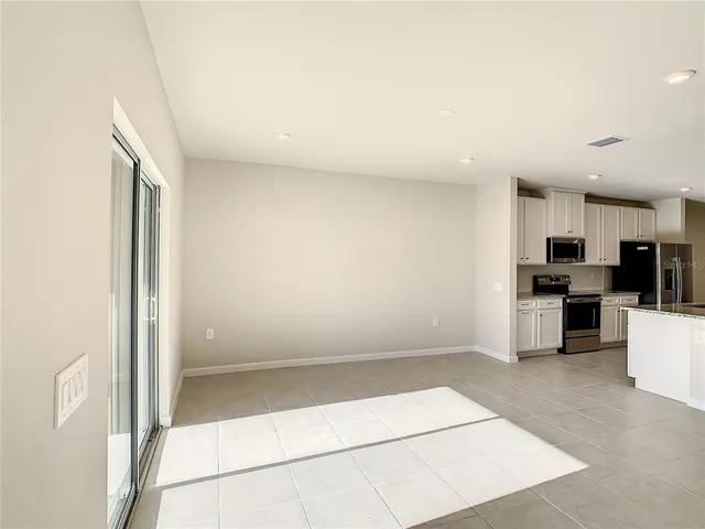 a view of kitchen with microwave and cabinets