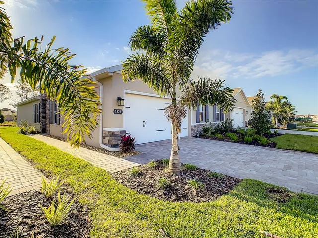a view of a house with a small yard and plant