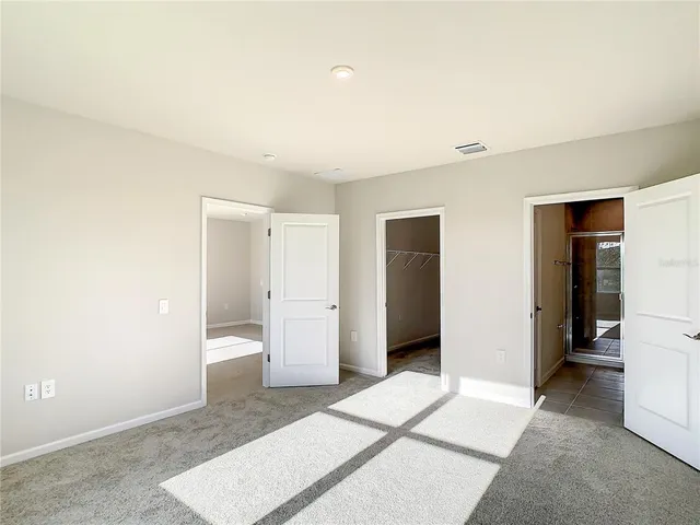a view of livingroom with walk in closet and bedroom