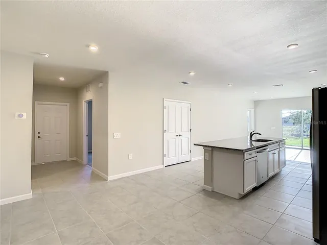 a kitchen with stainless steel appliances a stove and more cabinets