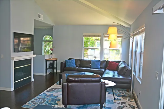 a living room with furniture a window and a flat screen tv