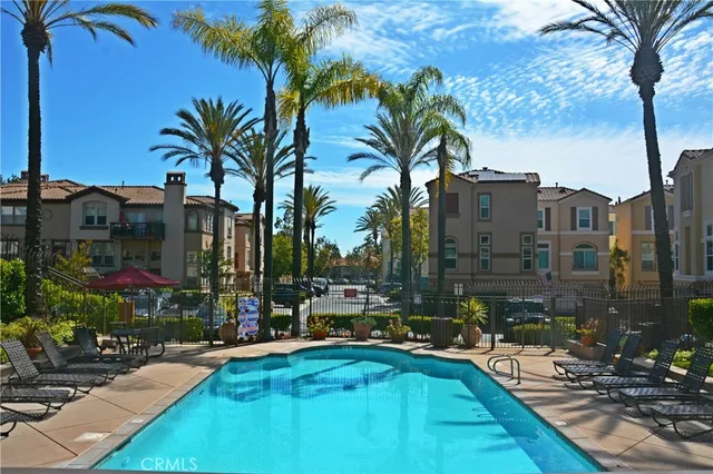 a view of swimming pool with outdoor seating and a pathway