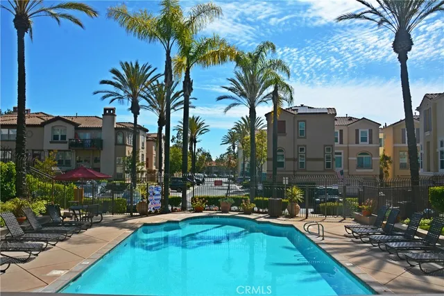 a view of swimming pool with outdoor seating and a pathway