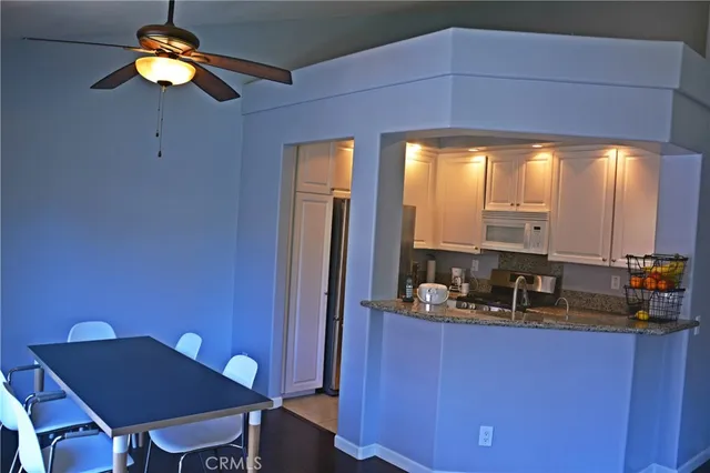 a kitchen with a table chairs and chandelier