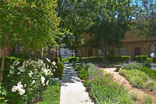 a view of a house with a big yard and large trees