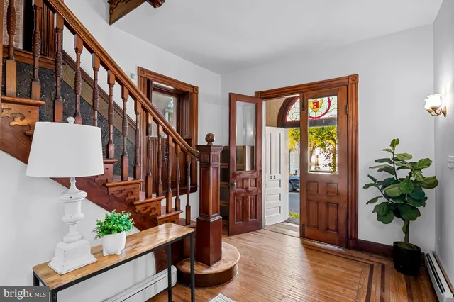 a view of an entryway with wooden floor and a potted plant
