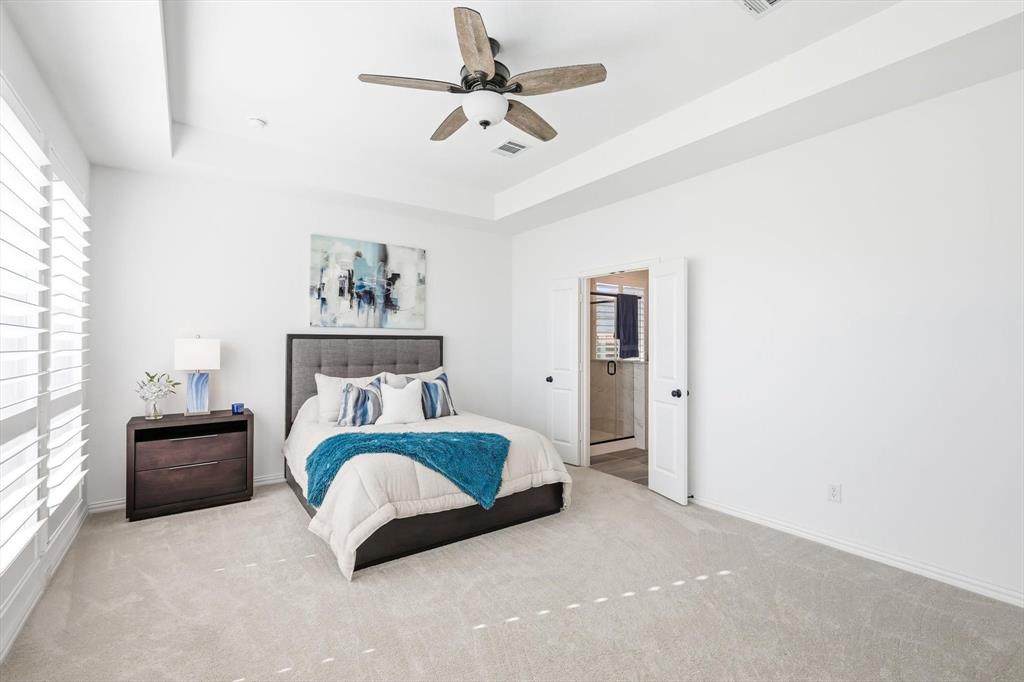 2171 Cloverfern Way Haslet, TX 76052 - Photo 14 of 38 a spacious bedroom with a bed and ceiling fan